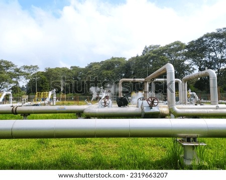 Geothermal steam energy factory, renewable green energy industry. Geothermal steam power plant, steam pipelines, alternative renewable energy in the world. kamojang, West Java, Indonesia.