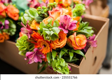 gerbera, tulips and mix of summer flowers bouquet for the wedding in the Florida. Orange roses, lily and gerbera flowers bouquet in the brown box getting ready for delivery 