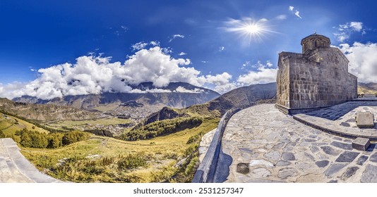 Gergeti Trinity Church near Stepantsminda, Georgia, with stunning views of the Caucasus mountains during daytime - Powered by Shutterstock