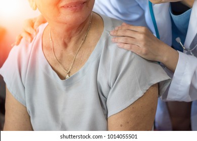 Geriatric Doctor Or Geriatrician Concept. 
Doctor Physician Hand On Happy Elderly Senior Patient To Comfort In Hospital Examination Room Or Hospice Nursing Home.