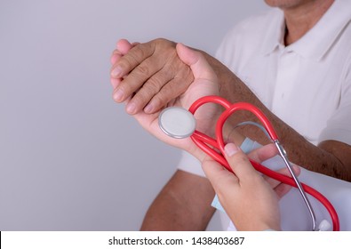 Geriatric Doctor Or Geriatrician Concept. Doctor Physician Hand On To Elderly Senior Patient To Comfort In Hospital Examination Room, Hospice Nursing Home.