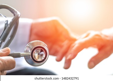 Geriatric Doctor Or Geriatrician Concept. Doctor Physician Hand On Happy Elderly Senior Patient To Comfort In Hospital Examination Room Or Hospice Nursing Home Or Wellbeing County. 