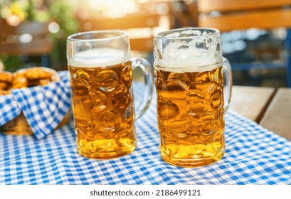 German Beer Mugs In A Beer Garden, At Summer In Munich, Germany