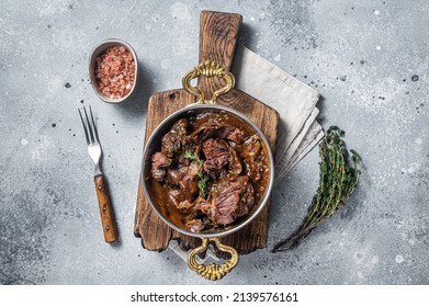 German Braised Beef Cheeks In Brown Red Wine Sauce. Gray Background. Top View.