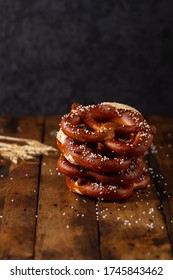 German Brezel Pretzel With Salt On Wooden Background