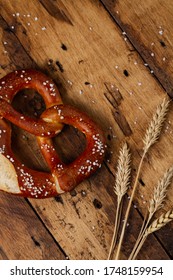 German Brezel Pretzel With Salt On Wooden Background