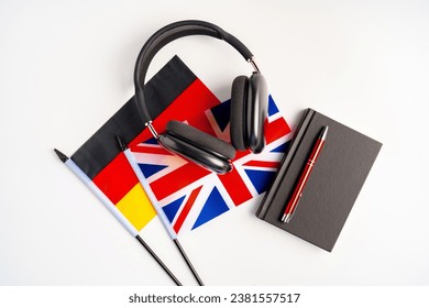 German and British flags with notepad on white background