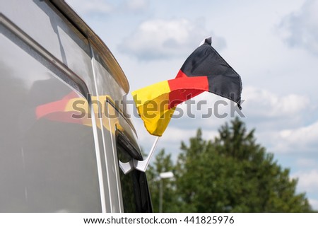 German flags on the roof of a soccer fan’s car