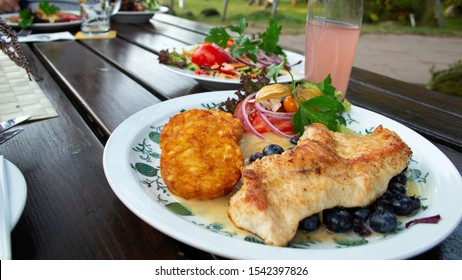 German Cuisine: Grilled Turkey With Hash Browns And Salad