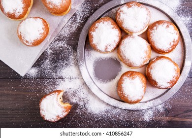 German donuts - berliner with jam and icing sugar in a tray on a dark wooden background. Top view - Powered by Shutterstock