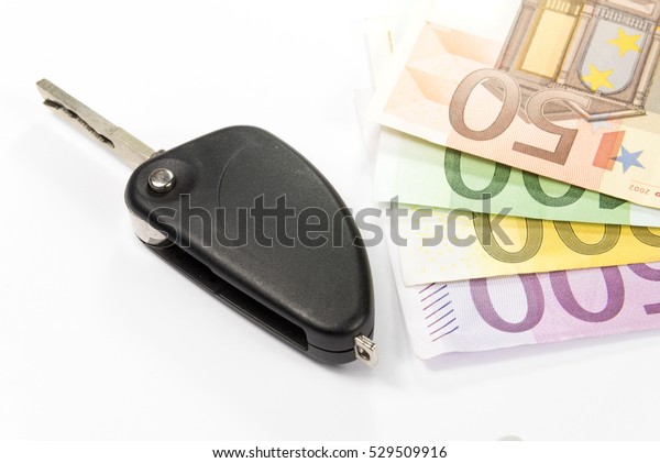 A German\
driving license, car keys and euro\
money
