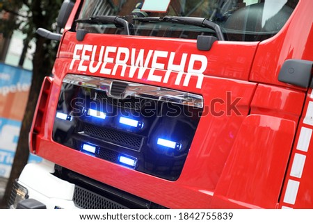 German fire engine in action with alarm light / Feuerwehr means Fire Department