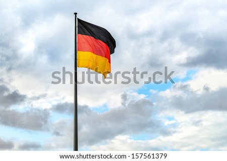 Similar – Waving German flag in front of a blue sky with clouds, Hallig Oland in the background