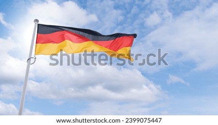 Similar – Waving German flag in front of a blue sky with clouds, Hallig Oland in the background