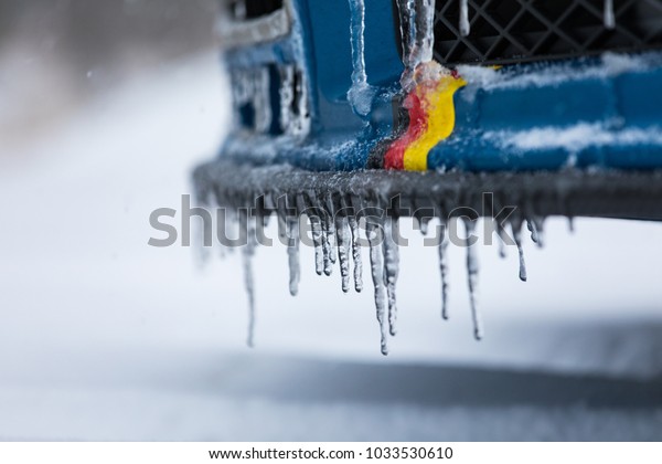 German flag on a car\'s spoiler and some frozen\
water drops