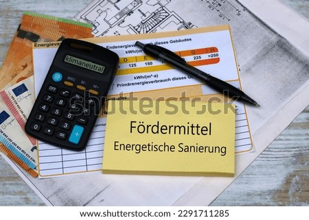 German funding program for renewable energies. Energy performance certificate, blueprint with money and notepad.
German text means funding for energetic renovation.