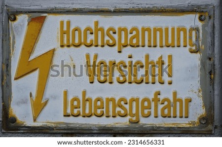 german high tension warning sign on a historic machine
