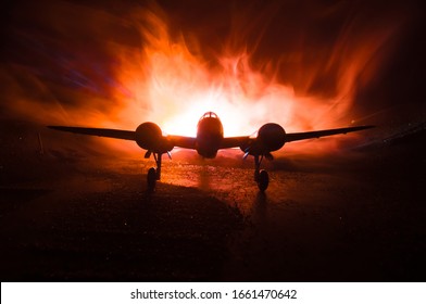 German Junker (Ju-88) night bomber at night. Artwork decoration with scale model of jet-propelled plane in possession. Toned foggy background with light. War scene. Selective focus