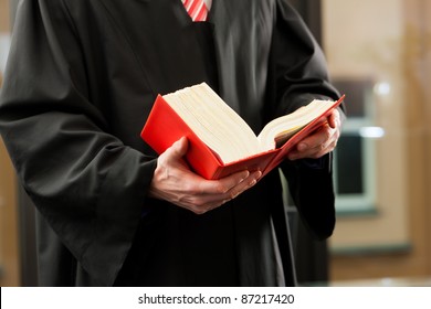 German Lawyer With Civil Law Code In A Court Room, Close-up, Only Torso To Be Seen