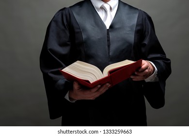 German Lawyer With A Classical Black Robe, White Tie And A Book