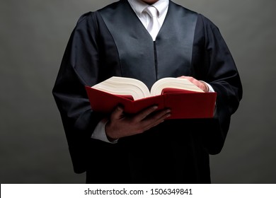 German Lawyer With A Classical Black Robe, White Tie And Book