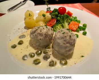 German Meatballs “Königsberger Klopse” On Caper Sauce With Vegetables And Boiled Potatoes