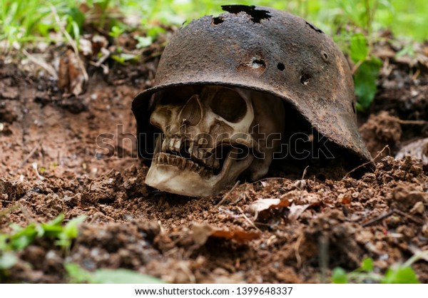 German military helmet. Third Reich.human skull.The Second World War. leaky and rusty military German helmet. archeological find.