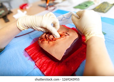 German Military Medic Practice Bleeding Control On A Wound Dummy