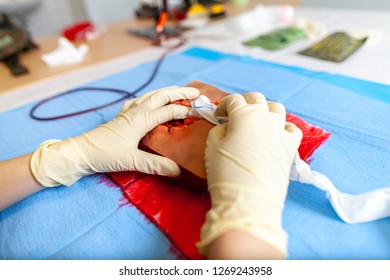 German Military Medic Practice Bleeding Control On A Wound Dummy