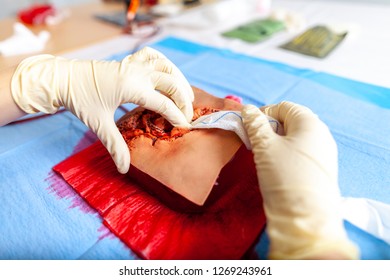 German Military Medic Practice Bleeding Control On A Wound Dummy