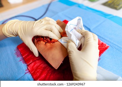 German Military Medic Practice Bleeding Control On A Wound Dummy