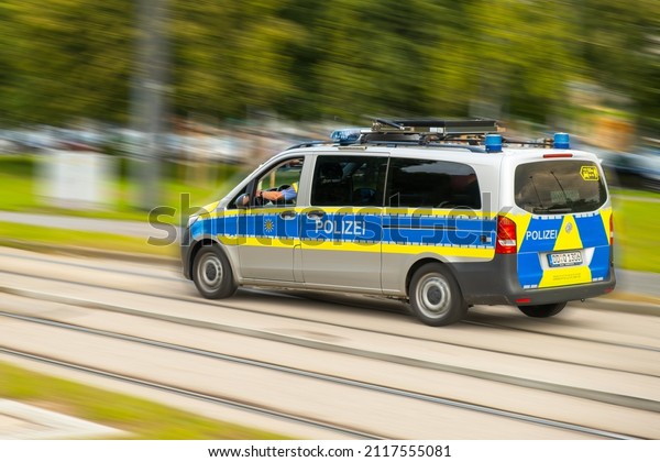  German police car with\
letters Polizei drives fast on call on the street. Police car\
hurrying up on an accident on blurred street, January 2022,\
Dresden, Germany.