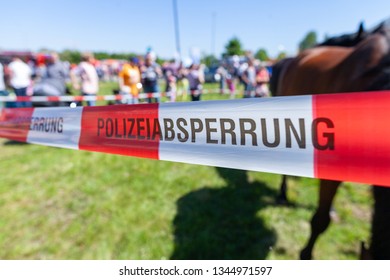 German Police Tape Hangs On A Crime Scene. Polizeiabsprerrung Means Police Cordon