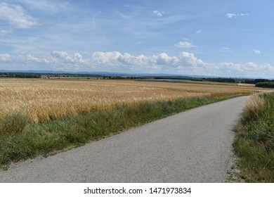 German road between wheat fields