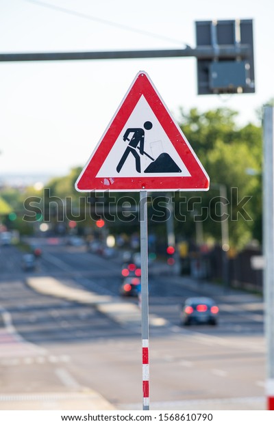 German
Roadworks sign 123 indicating a construction site nearby. cars are
visible in the background. portrait
orientation