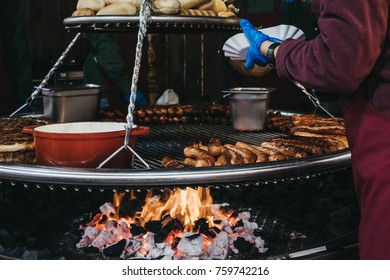 German sausages cooked on a large grill at an outdoor festival  - Shutterstock ID 759742216