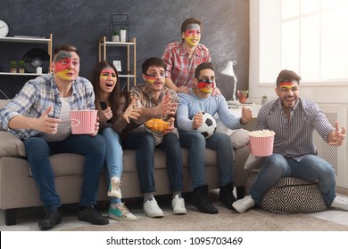 German sport fans with colored faces cheering and watching match at home. Leasure, sport concept - Powered by Shutterstock