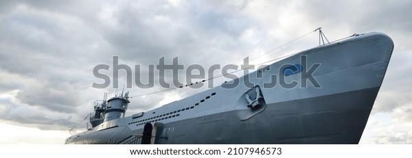German submarine U-995. Dramatic sky, storm\
clouds. Museum ship, Laboe Naval Memorial. Germany. Panoramic view.\
Travel destinations, landmarks, sightseeing, history, past, war,\
WW2, nautical vessel