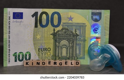 The German Word For Child Benefit, A 100 Euro Bank Note And A Pacifier