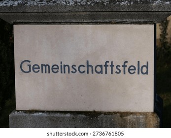 German Word Community plot on the gravestone. A community plot for families in a cemetery, often referred to as a family community grave, is a specially designated area in which several urns (more rarely coffins) of relatives are buried together.