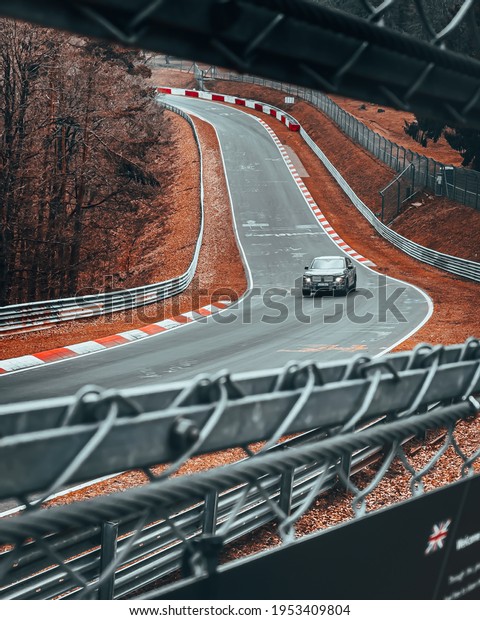 Nürburgring, Germany -\
03.25.2021: Shallow depth of the filed of a car driving on a racing\
track in Germany