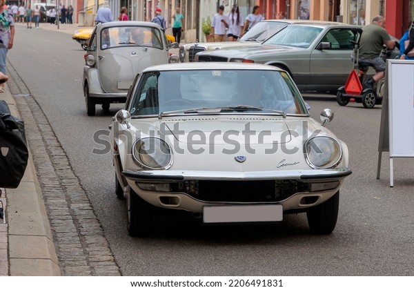Germany Donauwörth 08-27-2022, gray Mazda Cosmo\
Sport 110 S in drive on the\
road
