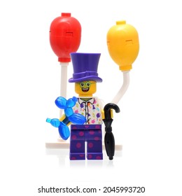 Lörrach, Germany - 09 22 2021: Lego Minifigure Clown With Umbrella And Baloon Dog Isolated On White. Editorial Illustrative Image Of Holiday Entertainment.