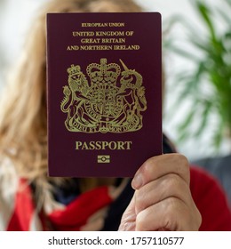 Osnabrück, Germany - 13 June 2020: Woman Holding Red British Passport 