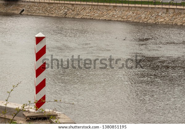 GÖRLITZ, GERMANY -\
APRIL, 2019: Polish border pillar near the Lusatian Neisse River\
that dividing the cities of Görlitz and Zgorzelec. Internal border\
of the European Union