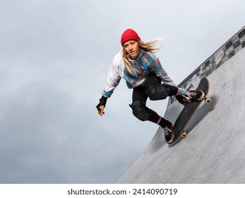 Germany- baden-wurttemberg- waiblingen- young woman skateboarding in skate park