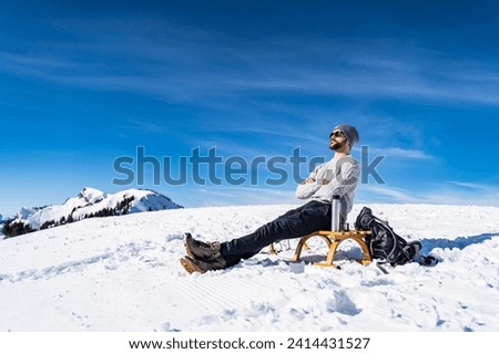 Germany- bavaria- brauneck- man in winter in the mountains having a break