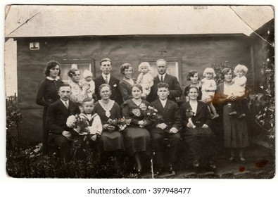 GERMANY - CIRCA 1940s: Vintage Photo Shows A Big Family Poses Behind House.  Black & White Antique Photography.