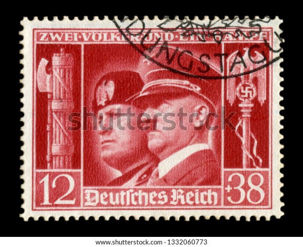 GERMANY - CIRCA 1941:  German historical stamp: German-Italian brotherhood in arms, Portraits of Hitler and Mussolini with symbols of the Nazi and fascist regime of the two countries, the Third Reich