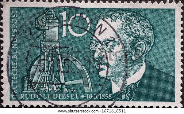 GERMANY - CIRCA 1958: a postage\
stamp printed in Germany showing a Portrait of engineer Rudolf\
Diesel with part of a photo in the background. For the 100th\
birthday